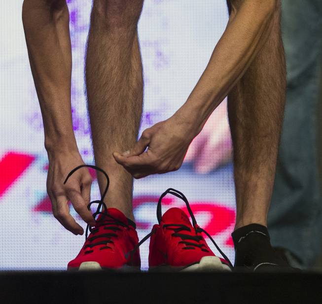 Bantamweight George Roop unties his red shoes during the UFC 175 weigh ins at the Mandalay Bay Resort on Friday, July 4, 2014.
