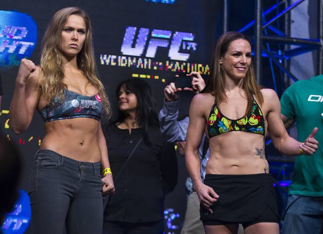 Ronda Rousey and Alexis Davis pose during the weigh-in for their UFC 175 bantamweight fight at Mandalay Bay on Friday, July 4, 2014.
