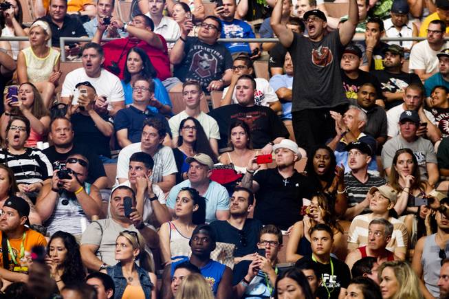 The crowd cheers for fighters during the UFC 175 weigh ins at the Mandalay Bay Resort on Friday, July 4, 2014.