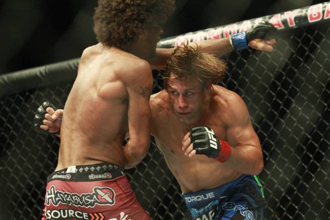 Urijah Faber ducks a punch thrown by Alex Caceres during their fight at UFC 175 at the Mandalay Bay Events Center Saturday, July 5, 2014. Faber won by submission in the third round.