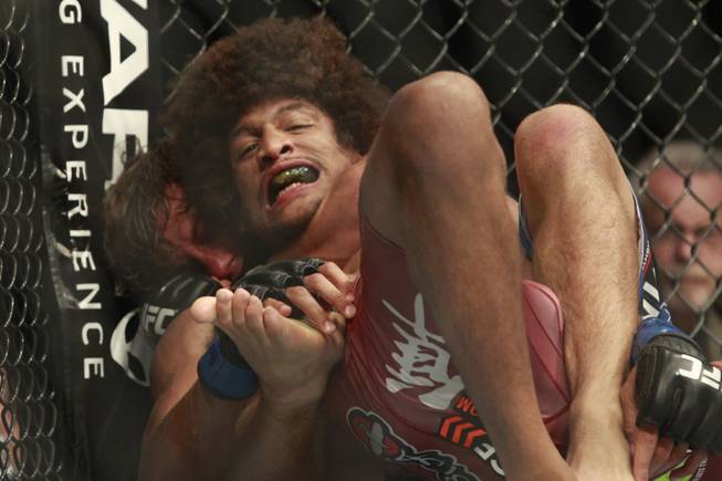 Urijah Faber submits Alex Caceres with a rear naked choke during the third round of their fight at UFC 175 at the Mandalay Bay Events Center Saturday, July 5, 2014.