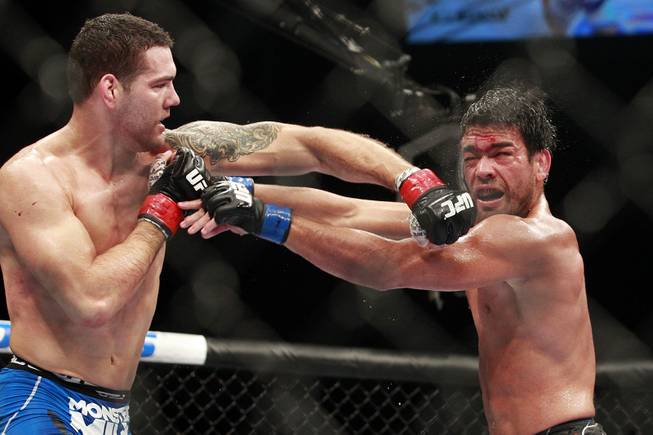 Chris Weidman hits Lyoto Machida with a left during their fight at UFC 175 at the Mandalay Bay Events Center Saturday, July 5, 2014. Weidman won a unanimous decision to retain his middleweight belt.