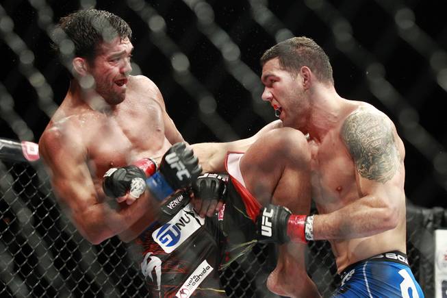Lyoto Machida throws a knee at Chris Weidman during their fight at UFC 175 at the Mandalay Bay Events Center Saturday, July 5, 2014. Weidman won a unanimous decision to retain his middleweight belt.