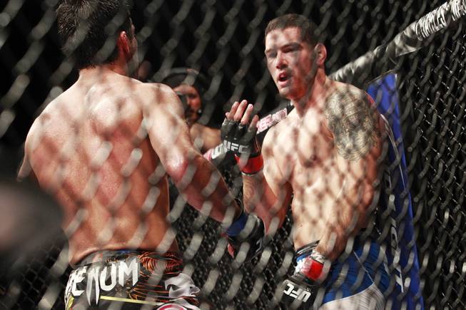 Chris Weidman beckons Lyoto Machida towards him during their fight at UFC 175 at the Mandalay Bay Events Center Saturday, July 5, 2014. Weidman won a unanimous decision to retain his middleweight belt.