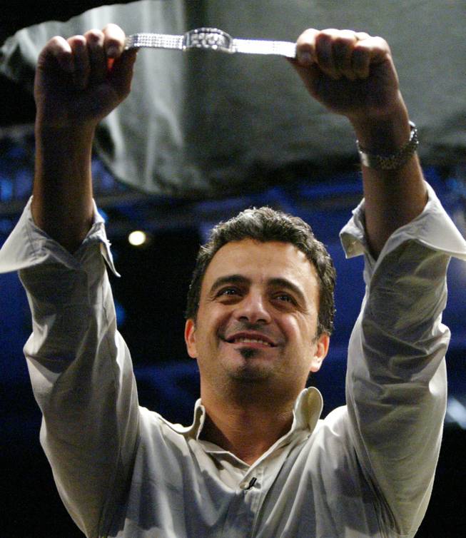 Australia's Joe Hachem holds the championship bracelet as he celebrates winning the World Series of Poker Main Event on Saturday, July, 16, 2005, at Binion's Gambling Hall and Hotel in Las Vegas after a final that lasted almost 14 hours.