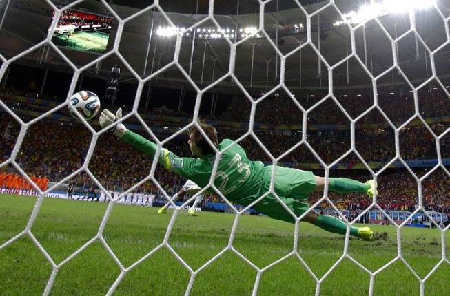 Netherlands goalkeeper Tim Krul makes a save on a shot by Costa Rica's Michael Umana during a penalty shootout at the Arena Fonte Nova in Salvador, Brazil, on Saturday, July 5, 2014. The Netherlands defeated Costa Rica 4-3 in penalties after a 0-0 tie.