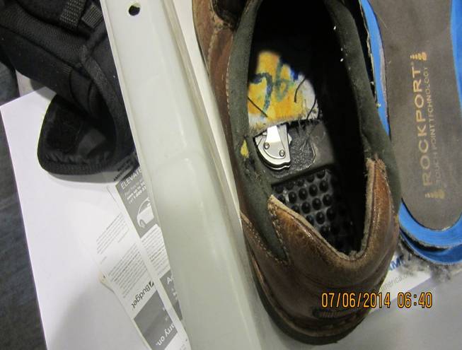 This July 6, 2014, photo provided by the Transportation Security Administration shows a knife concealed inside the bottom lining of a shoe belonging to a passenger at Detroit Metropolitan Airport in Romulus, Mich. The TSA says airport police responded, took possession of the knife and arrested the passenger.