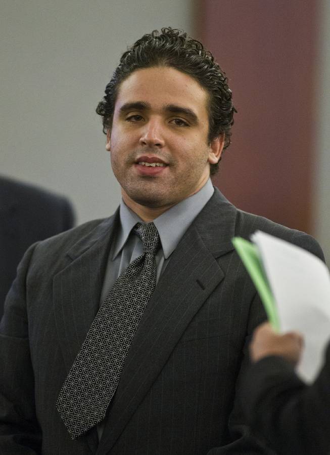 Joey Kadmiri smiles at jury members as they pass by during a break in his trial at the at the Regional Justice Center on Tuesday, July 8, 2014.