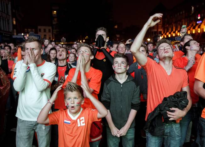 Soccer fans watch a live broadcast of the World Cup semifinal soccer match between Netherlands and Argentina on a giant screen in the center of Eindhoven, Netherlands, Wednesday, July 9, 2014. (AP Photo/Phil Nijhuis)
