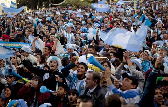 Argentina soccer fans cheer before watching the World Cup semifinal match between Argentina and Netherlands on an outdoor screen set up in Buenos Aires, Argentina, Wednesday, July 9, 2014. 
