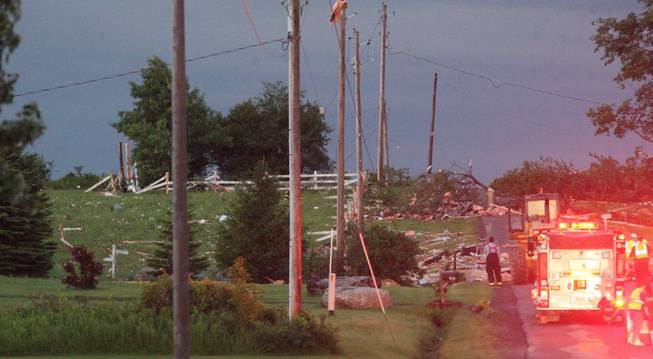 Debris is visible at Goff Road in Smithfield, N.Y., following severe storm on Tuesday, July 8, 2014. Officials in central New York say four people are dead and four homes have been destroyed in building collapses amid severe thunderstorms.