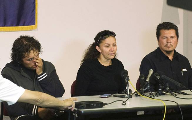 Cousin Gustavo Allende, left, mother Marisol Hernandez, center, and father Pablo Rubio speak to the press about homicide victim Rubi Rubio during a press conference at the Santa Ana Police Department Tuesday, July 8, 2014, in Santa Ana, Calif.
