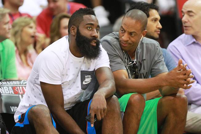 Houston guard James Harden, left, talks with Findlay Prep coach Jerome Williams during the NBA Summer League game between Cleveland and Milwaukee Friday, July 11, 2014 at the Cox Pavilion.