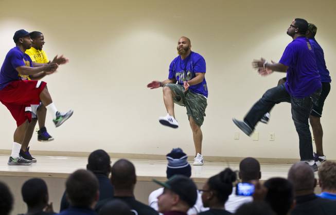 Members of the Omega Psi Phi Fraternity perform an opening dance for the "Stop the Violence" event at the Pearson Community Center on Saturday, June 28, 2014.