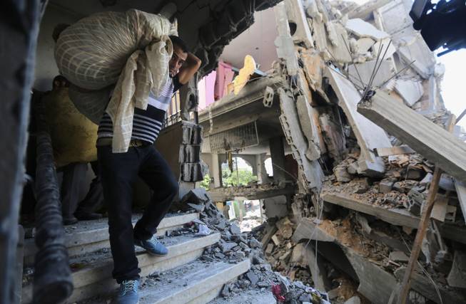 Palestinians after Israeli missile strike in Gaza/AP