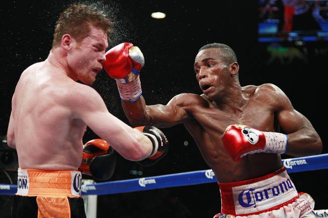 Saul "Canelo" Alvarez is hit by a right from Erislandy Lara during their super welterweight fight Saturday, July 12, 2014 at the MGM Grand Garden Arena. Canelo won a split decision.