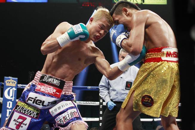Tomoki Kameda hits Pungluang Singyu with a left to the body during their WBO bantamweight title fight Saturday, July 12, 2014 at the MGM Grand Garden Arena. Kameda won with a 7th round knock out.
