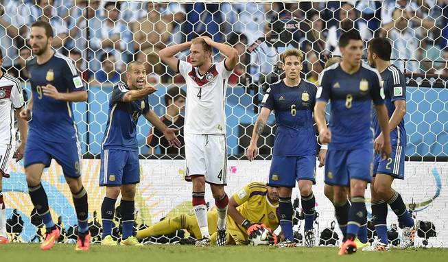 Germany's Benedikt Hoewedes (4) reacts after hitting the post with a header during the World Cup final soccer match between Germany and Argentina at the Maracana Stadium in Rio de Janeiro, Brazil, Sunday, July 13, 2014.