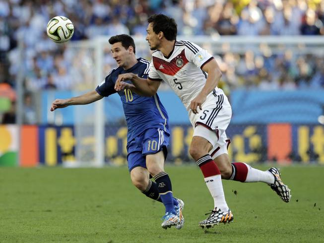 Argentina's Lionel Messi, left, battles for the ball with Germany's Mats Hummels during the World Cup final soccer match between Germany and Argentina at the Maracana Stadium in Rio de Janeiro, Brazil, Sunday, July 13, 2014.