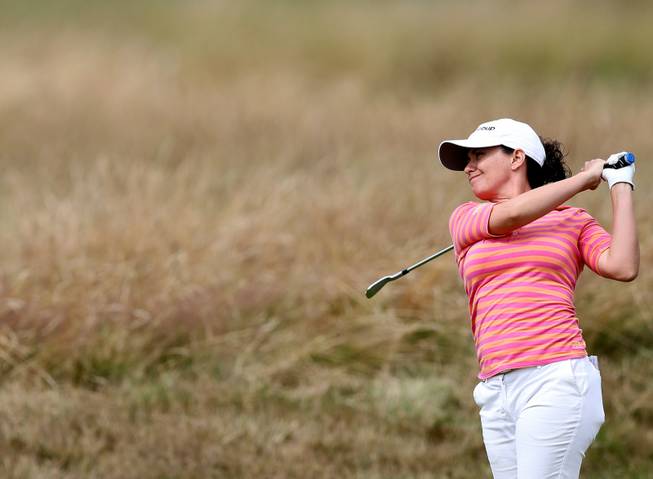 Mo Martin of the U.S. plays a shot on the 11th fairway during the third day of the Women's British Open golf championship at the Royal Birkdale Golf Club, in Southport, England, Saturday, July 12, 2014. She hit an eagle in the final day of play Sunday to win.