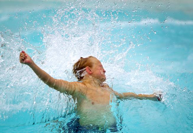 A boy is hit with a wave at the Cowbunga Bay water park in Henderson Monday, July 14, 2014. The new water park opened on July 4. STEVE MARCUS