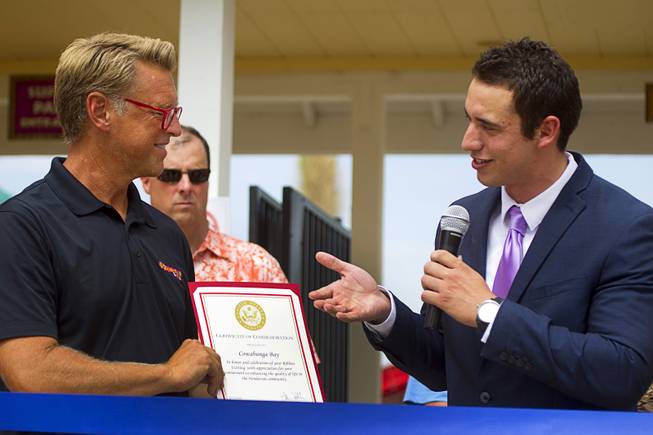 Stephen Sifuentes, right, representing Sen. Dean Heller, presents a certificate to Shane Huish, general manager of the Cowbunga Bay water park, during an official opening ceremony for the water park in Henderson Monday, July 14, 2014. The park opened on July 4. STEVE MARCUS