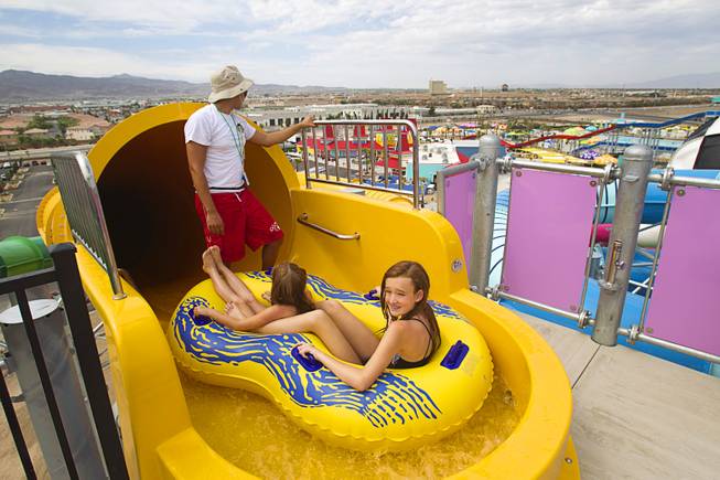 Lifeguard Jesus Sanchez holds up riders until the ride is clear at the Cowbunga Bay water park in Henderson Monday, July 14, 2014. The new water park opened on July 4. STEVE MARCUS