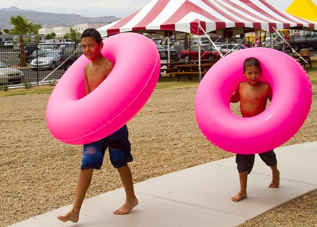 Brothers Giovanni Ramirez, left, 12, and his brother Thomas, 9, head to a ride at the Cowbunga Bay water park in Henderson Monday, July 14, 2014. The new water park opened on July 4. STEVE MARCUS