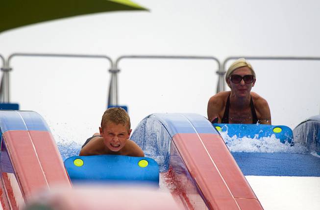 A boy heads down a slide at the Cowbunga Bay water park in Henderson Monday, July 14, 2014. The new water park opened on July 4. STEVE MARCUS