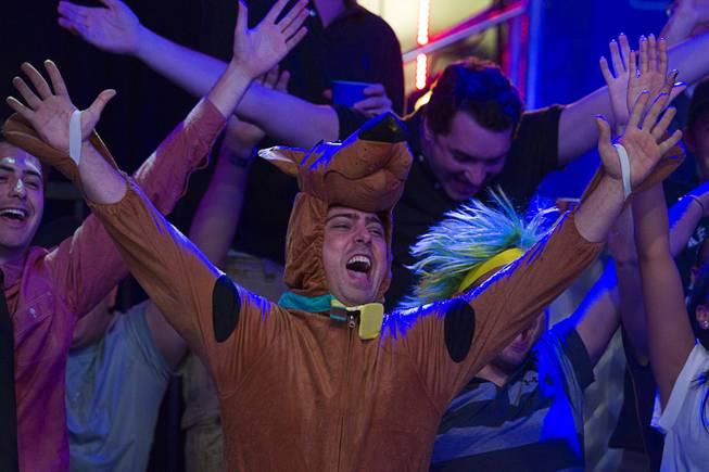 Igor Marane, a friend of Brazil's Bruno Politano, cheers with other supporters during the World Series of Poker $10,000 buy-in No-limit Texas Hold 'em main event at the Rio, July 14, 2014. Politano is the first Brazilian to make the WSOP Main Event final table. Marane dressed as Scooby Doo because he promised Politano that if he did well that he would support him in costume, he said. 