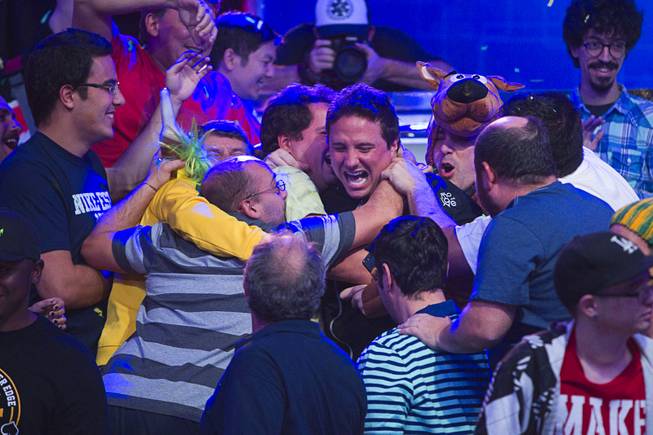 Bruno Politano, center, of Brazil celebrates with supporters after making it to the final table during the World Series of Poker $10,000 buy-in No-limit Texas Hold 'em main event at the Rio, July 14, 2014. Politano is the first Brazilian to make the WSOP Main Event final table.