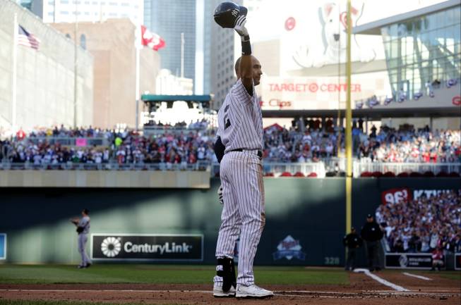 New York Yankees shortstop Derek Jeter waves to the crowd during the first inning of the MLB All-Star baseball game Tuesday, July 15, 2014, in Minneapolis.