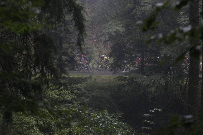 The pack rides through the Vosges mountains during the tenth stage of the Tour de France cycling race over 161.5 kilometers (100.4 miles) with start in Mulhouse and finish in La Planche des Belles Filles, France, Monday, July 14, 2014. 