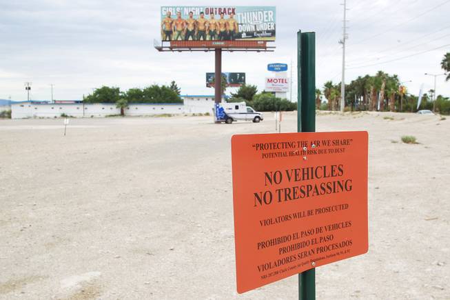 Disregarding posted signs, an AMR ambulance sits in a vacant lot on the south end of the Strip Tuesday, July 15, 2014.