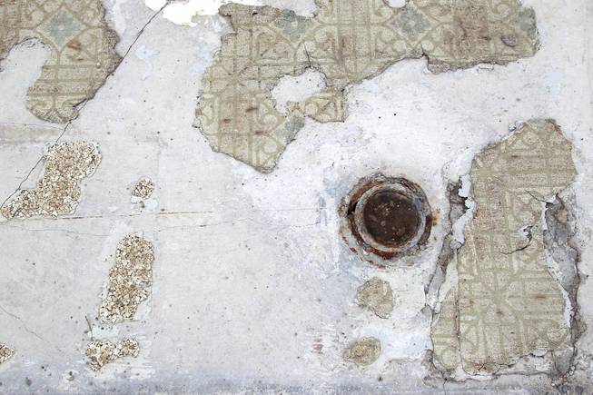 A concrete pad, showing remnants of vinyl tile in a bathroom, is all that remains of the Laughing Jackalope Motel on the south end of the Strip Tuesday, July 15, 2014.