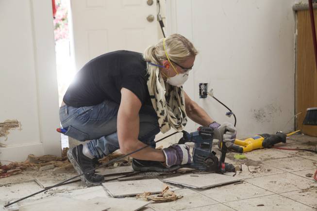 Interior designer Melissa Roche of Las Vegas competes in Season 2 of “Brother vs. Brother” on HGTV. Roche, pictured here, breaks up the tile floor in the kitchen of the McMahan home in the Arlington Heights neighborhood of Los Angeles. Roche, part of Team Drew, was crowned the champion on the finale Sunday, July 13, 2014.

