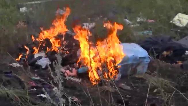In this image taken from video, Thursday July 17, 2014, showing flames rising from part of the wreckage of a passenger plane carrying 295 people after it was shot down Thursday as it flew over Ukraine, near the village of Hrabove, in eastern Ukraine. Malaysia Airlines tweeted that it lost contact with one of its flights as it was traveling from Amsterdam to Kuala Lumpur over Ukrainian airspace. 