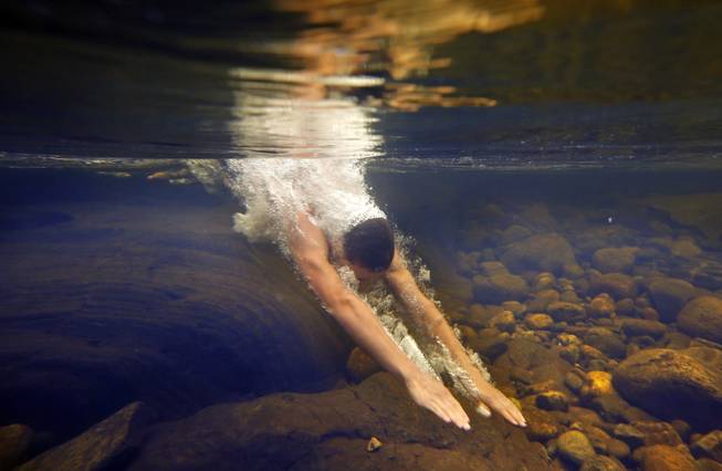 AP10ThingsToSee - Russell Norris, 15, of Tylertown, Miss., dives into the chilly Swift River at Coos Canyon in Byron, Maine. The canyon is considered one of the premier swimming holes in the U.S. 