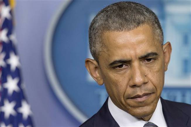 President Barack Obama pauses while speaking about the situation in Ukraine, Friday, July 18, 2014, in the Brady Press Briefing Room of the White House in Washington. Obama called for immediate ceasefire in Ukraine and demanded a credible investigation of downed plane.
