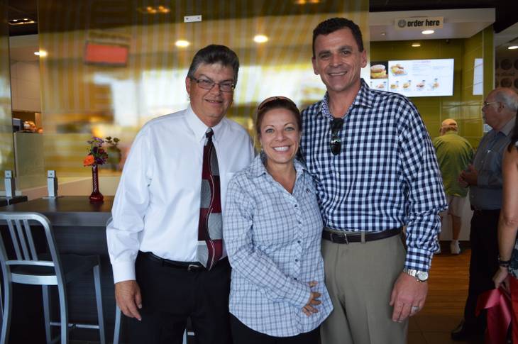 Caption: Owner of a new McDonald's location in Las Vegas, Tim Thomas (left), poses for a photo at the grand opening with fellow McDonald's operators Samantha Kiel and Michael Kiel.