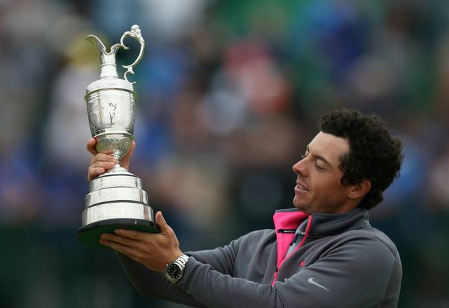 Rory McIlroy holds up the Claret Jug trophy after winning the British Open golf championship at Royal Liverpool Golf Club in Hoylake, England, on Sunday, July 20, 2014.