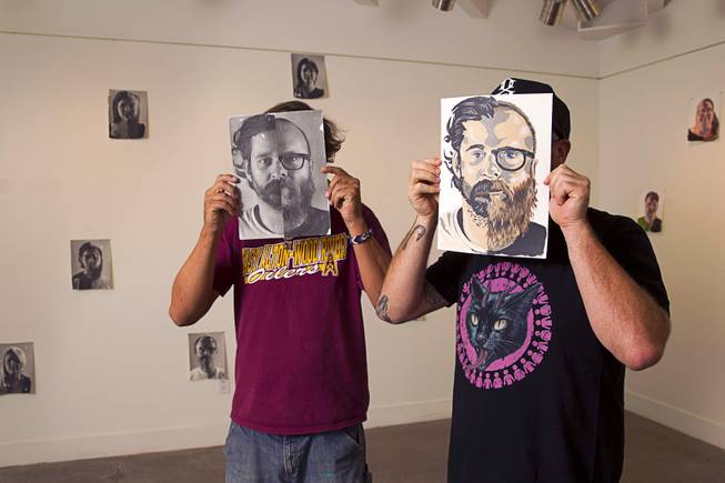 Photographer Todd Duane Miller, left, and artist JW Caldwell pose in the P3 Studio in the Cosmopolitan Monday, July 21, 2014. For their project, Miller combines portraits of people and Caldwell creates artwork from the composite photos. The photo displayed is half Miller (left side) and half Caldwell.