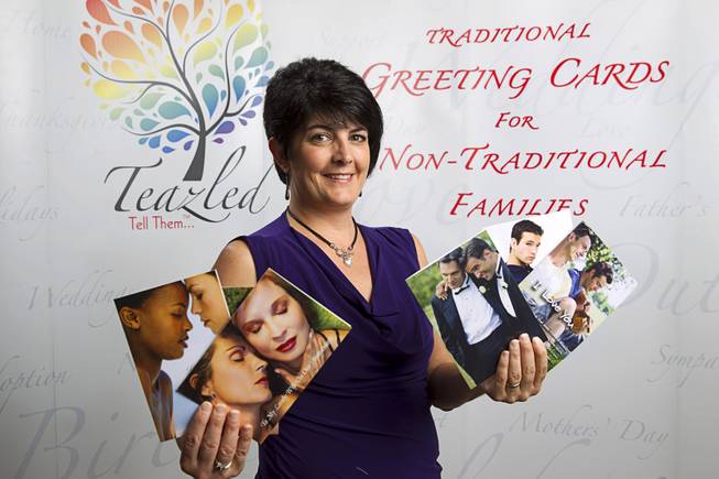 Teazled CEO Dina Proto poses with greeting cards at her office Monday, July 21, 2014. Teazled is a company that makes "traditional greeting cards for nontraditional familes."