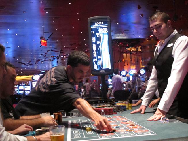 In this May 21, 2012 photo, a dealer watches as gamblers place bets on a roulette table at Revel Casino Hotel in Atlantic City, N.J. Revel is one of three Atlantic City casinos that could close by September in a wave of casino contraction that could be a glimpse of the future for other parts of the country with too many casinos and not enough gamblers to support them. 