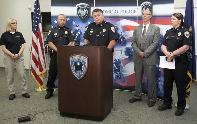 Wyoming police Chief James Carmody, middle, holds a press conference about the triple homicide of Charles Oppenneer, Brooke Slocum and her unborn child at the Wyoming, Mich., Police Department Monday, July 21, 2014. 