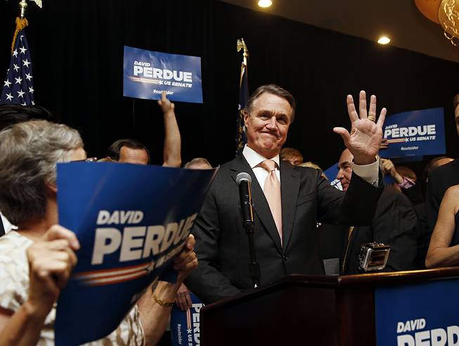David Perdue waves to supporters after declaring victory in the Republican primary runoff for nomination to the U.S. Senate from Georgia, at his election-night party in Atlanta, Tuesday, July 22, 2014. Perdue defeated Rep. Jack Kingston. 
