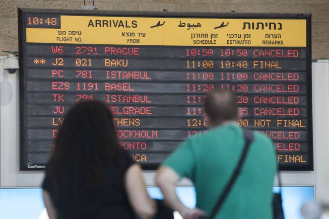 An arrivals flight board displays various canceled and delayed flights at Ben Gurion International Airport a day after the U.S. Federal Aviation Administration imposed a 24-hour restriction on flights in Tel Aviv, Israel, Wednesday, July 23, 2014.
