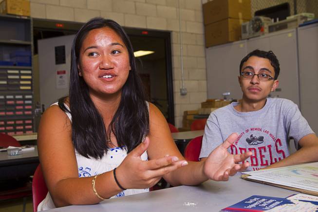 Katherine Lau, a biomedical engineering student from Rutgers University, speaks during an interview at UNLV Thursday, July 17, 2014.  Kareem Trabia, an A-Tech High School senior, listens at right. An engineering team at UNLV is designing a "robohand" for 4-year-old Hailey Dawson using the school's 3D printer. Dawson was born with a birth defect that left her only with a thumb and pinky on her left hand.