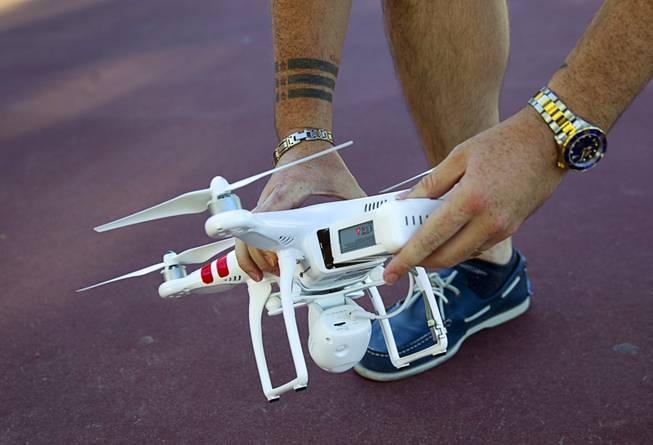 Earl Brown puts a fresh battery in his DJI Phantom 2 Vision quadcopter drone at The Hills Park in Summerlin Thursday, July 24, 2014.  Brown turned to Craigslist after losing the drone on a flight earlier in the month.