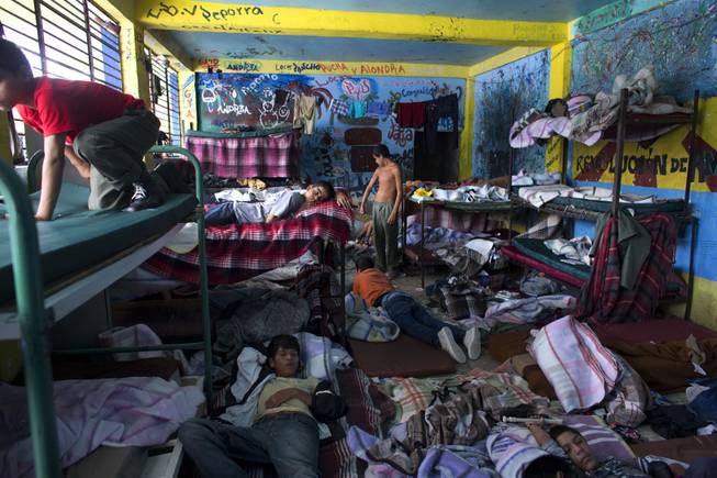 AP10ThingsToSee - Boys watch television in their room at The Great Family group home, in Zamora, Mexico, Thursday, July 17, 2014. After a police raid on the refuse-strewn group home Tuesday, residents of the shelter told authorities that some employees beat residents, fed them rotting food or locked them in a tiny "punishment" room. 